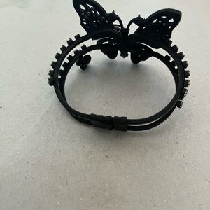 Butterfly bracelet with clear stones on butterfly and both sides.